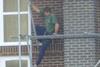 Man balancing on scaffold pole
