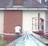 Man on ladder on conservatory roof