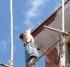 Worker balanced on scaffold poles