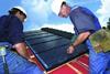 Operatives install PV 800 photovoltaic panels. Excess electricity can be sold to the National Grid 