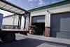 CCTV surveillance covers the rear access delivery area sited within a gated chain-fenced security enclosure