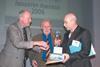 BBSA President Paul Woodman (left) presents the award to Louvolite Director of Business Development Steve Birtles (right), with inventor Trevor Baylis (centre)