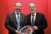 Glenn Taylor (left) receives the award from LHC Director Dr Eli Kienwald