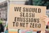 Protest sign saying we should slash emissions to net zero
