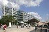 A huge office replaces half of the old Spitalfields market building but its bulk is masked by landscaped public spaces and a retained wing of the old building