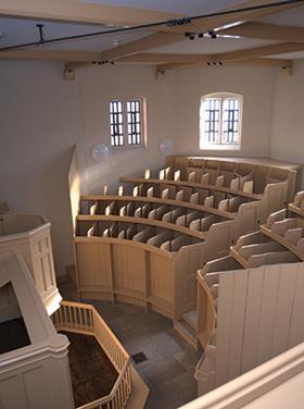 The unique seating pews in the restored chapel were designed to isolate each prisoner 