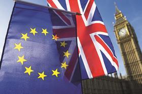 Union Jack and EU flag in front of Palace of Westminster