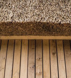 The thatch is complemented by other natural materials such as timber