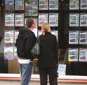 Couple at Estate Agent window 