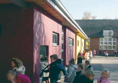 Pupils at Springhill Catholic Primary School in Southampton swarm around their new classroom block, designed by architecture plb