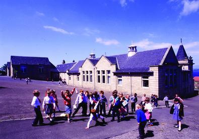 Children play in the grounds of Bo’ness Primary School, Scotland