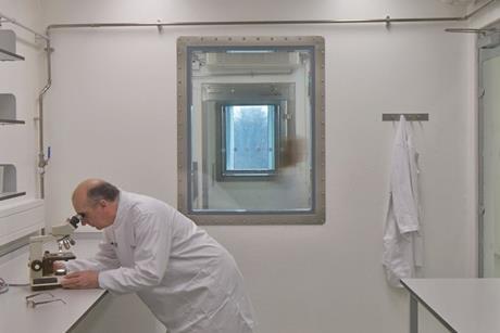 A Pirbright Institute scientist working inside a high-containment laboratory in the institute’s Plowright Building