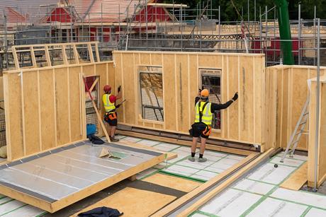 Construction Workers Installing Wall Panel