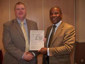 Martin Fahey, newly elected member of the CIBSE East Midlands Regional Committee, receives his much-deserved prize from Chairman Densel.
