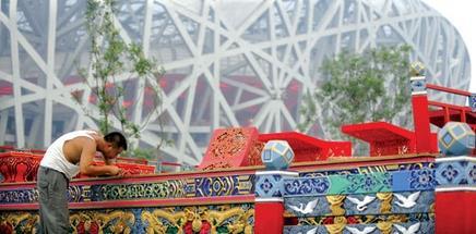 A worker in Beijing carries out last-minute preparations for tonight’s Olympic opening ceremony