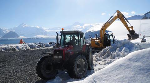 NACredit Chris Lloyd BAM excavator clearing snow from into trailer towed by BAS tractor & drive 040121