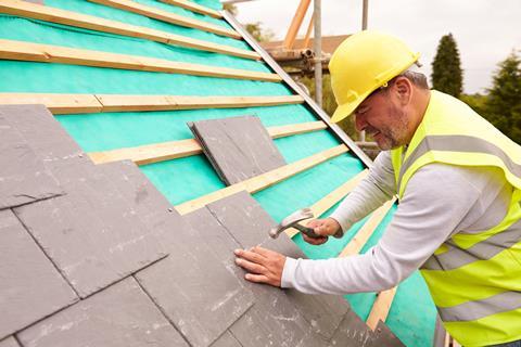 Man installs slate roof
