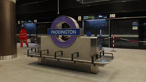 A construction worker walking along Paddington Crossrail station platform