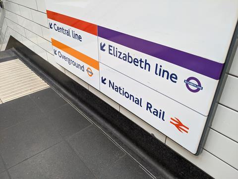 Sign at Liverpool Street station with arrows pointing down to Central, Overground and Elizabeth Line routes
