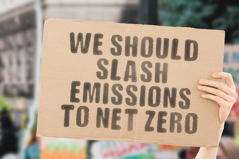 Protest sign saying we should slash emissions to net zero
