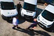 Three vans branded with Carillion logo