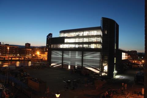 The site’s stacked form at night