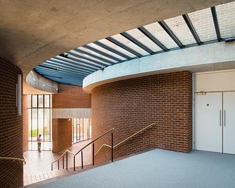 A new rooflight spans restored brickwork and concrete in the foyer