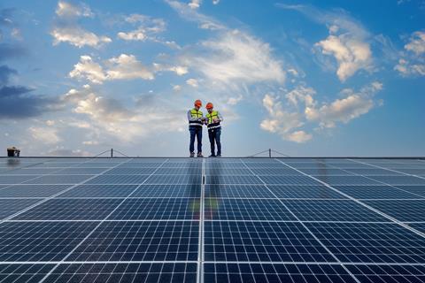 Engineers inspect a flat roof solar installation