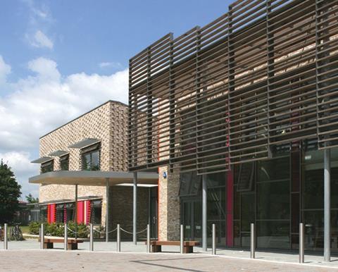 The elevations are marked by textured brickwork and a full-height brise soleil