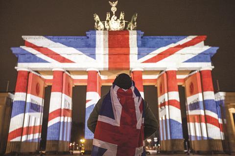 A member of the public, wrapped in a Union Jack, watches as the Brandenburg Gate in Berlin, Germany, is lit in the colours of the British flag, last week. The display was projected as an act of solidarity with the victims of last Wednesday’s terror attack