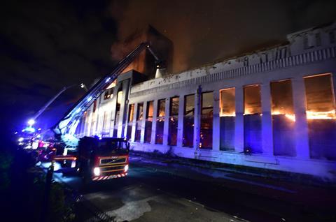 Firefighters douse the burning Littlewoods ɫTV in Liverpool