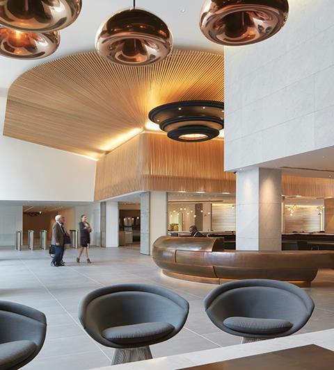 With its brass lights and copper desk, the office foyer assumes the nautical theme present in much of the building