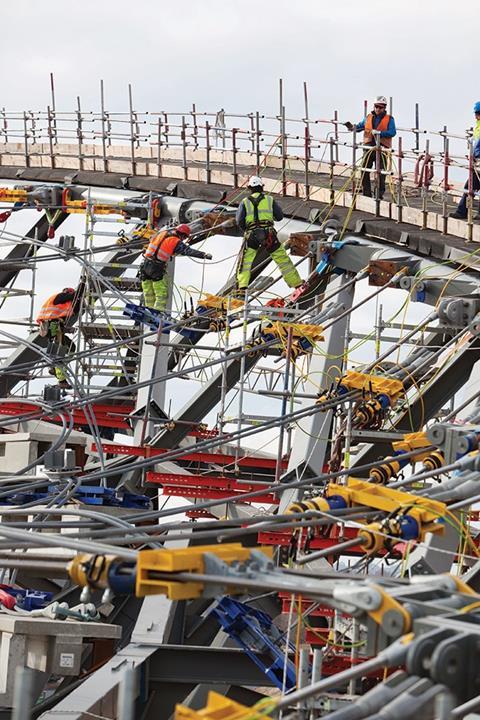 Workers construct the cable net roofing on the 2012 Olympic Velodrome. As with all other major London 2012 venues, it was procured under an NEC3 Engineering and Construction Contract option C
