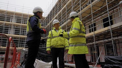 Trio on roof with scaff