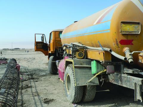 A constant stream of trucks keep the site supplied