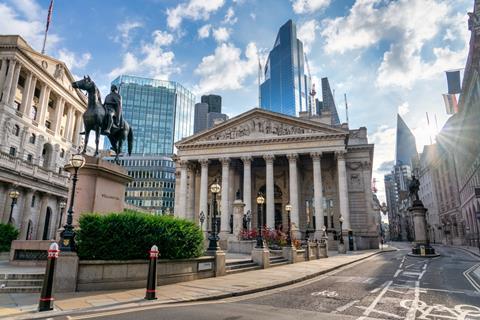 Royal exchange in London with city skyscrapers in background