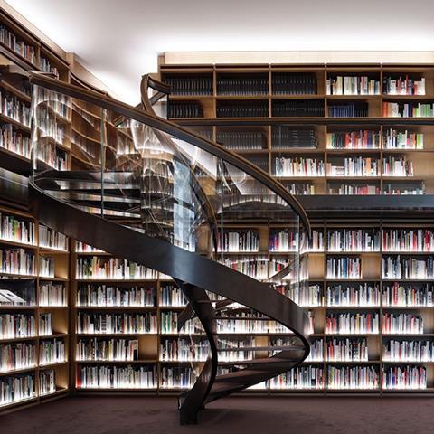 An elegant helical staircase is the primary feature in the museum library