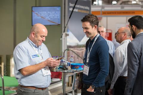 UKCW - Exhibitor talking to visitor at UK Construction Week 